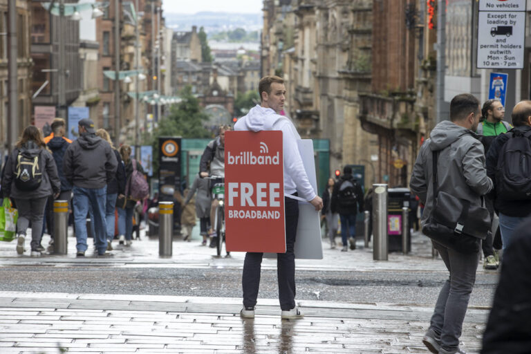 Duncan Di Biase, founder of Brillband Broadband in Glasgow Street with Free Broadband sign